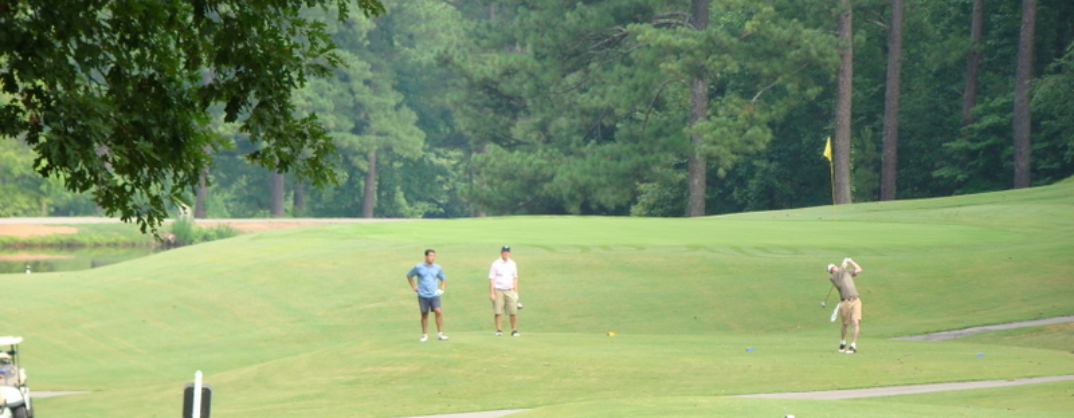 Golfers on golf course green